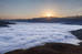 Sonnenaufgang über den Wolken am Pass Piche Bon